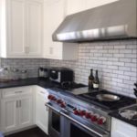 white-candied-brick-backsplash-with-black-absolute-granite-counters