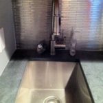 granite-countertop-with-metal-brick-backsplash